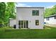 This home's backyard features a flat lawn with sliding glass doors, leading to an indoor living space and updated home at 2926 5Th Sw St, Atlanta, GA 30315