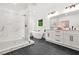 This contemporary bathroom features marble accents, black fixtures, a double vanity, and a separate shower and soaking tub at 2926 5Th Sw St, Atlanta, GA 30315