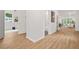 Bright hallway with hardwood floors that leads to the living room and bathroom at 2926 5Th Sw St, Atlanta, GA 30315