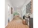 Bright hallway with hardwood floors and modern decor that leads to the living room at 2926 5Th Sw St, Atlanta, GA 30315