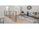 Upstairs hallway with modern railing and a cozy seating area at 2926 5Th Sw St, Atlanta, GA 30315