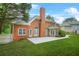 Brick home featuring a concrete patio, large yard, and mature trees at 110 Glen Eagle Way, Mcdonough, GA 30253