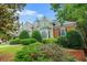 Landscaped front yard of an elegant brick and stucco home at 110 Glen Eagle Way, Mcdonough, GA 30253