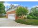 Side view of house with attached brick garage and driveway at 110 Glen Eagle Way, Mcdonough, GA 30253