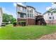 Well-maintained backyard featuring a manicured lawn, brick accents, and a charming covered deck at 2100 Willshire Gln, Alpharetta, GA 30009