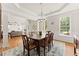 An elegant dining room with hardwood floors, a chandelier, and a view into the living room at 2100 Willshire Gln, Alpharetta, GA 30009