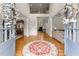A grand entryway with hardwood floors, a high ceiling, decorative columns, and a view into the living spaces at 2100 Willshire Gln, Alpharetta, GA 30009