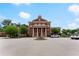 Beautiful brick building with grand columns and a symmetrical design, set against a bright blue sky at 2100 Willshire Gln, Alpharetta, GA 30009