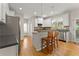 Cozy kitchen with stainless steel appliances, wooden breakfast bar stools, and hardwood floors at 2100 Willshire Gln, Alpharetta, GA 30009