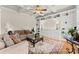 A cozy living room featuring coffered ceilings, built-in shelving, plush seating, and hardwood floors at 2100 Willshire Gln, Alpharetta, GA 30009