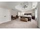 Spacious main bedroom features a ceiling fan, carpet, an ensuite bathroom, and a large bed at 2100 Willshire Gln, Alpharetta, GA 30009