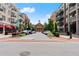Street view of a town square showcasing a grand building flanked by retail shops and residential buildings at 2100 Willshire Gln, Alpharetta, GA 30009