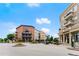 Charming town square featuring brick buildings with balconies and street-level shops under a blue sky at 2100 Willshire Gln, Alpharetta, GA 30009