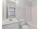 Bright bathroom features a white vanity and toilet, with a glimpse of the hallway at 3425 Sable Chase Ln, South Fulton, GA 30349