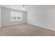 A carpeted bedroom features a window, a ceiling fan, and neutral decor at 3425 Sable Chase Ln, South Fulton, GA 30349