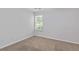 A carpeted bedroom features a window, neutral decor, and ample natural light at 3425 Sable Chase Ln, South Fulton, GA 30349