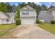 Exterior view of home featuring a two-car garage and manicured front lawn at 3425 Sable Chase Ln, South Fulton, GA 30349