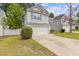 Exterior shot of a home, with a two-car garage, small front lawn, and driveway at 3425 Sable Chase Ln, South Fulton, GA 30349