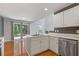 Bright kitchen with white cabinets, stainless steel appliances, an island sink and hardwood floors at 3425 Sable Chase Ln, South Fulton, GA 30349