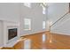Bright living room featuring hardwood floors, a fireplace, and a staircase to the second floor at 3425 Sable Chase Ln, South Fulton, GA 30349