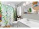 Cozy bathroom featuring a stylish vanity, toilet, and shower with unique curtain at 486 Buttercup Trl, Lawrenceville, GA 30046