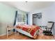 Cozy bedroom with a window and closet; furnished with a twin bed and comfortable rocking chair at 486 Buttercup Trl, Lawrenceville, GA 30046