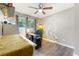 Comfortable bedroom with hardwood floors, natural light from the windows, and desk space at 486 Buttercup Trl, Lawrenceville, GA 30046