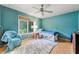 Bedroom with wood floor and ceiling fan offering a calming atmosphere for relaxation at 486 Buttercup Trl, Lawrenceville, GA 30046