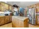 Spacious kitchen featuring light countertops, wood cabinets, and stainless-steel appliances, plus stairs at 486 Buttercup Trl, Lawrenceville, GA 30046