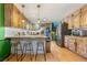 Stylish kitchen with brick accents, light-wood cabinets, bar seating, and stainless-steel appliances at 486 Buttercup Trl, Lawrenceville, GA 30046