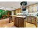 Rustic kitchen featuring wood cabinets, central island, and stainless-steel appliances, plus dining area at 486 Buttercup Trl, Lawrenceville, GA 30046