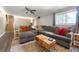 Spacious living room featuring a sectional sofa, hardwood floors, and natural lighting at 486 Buttercup Trl, Lawrenceville, GA 30046