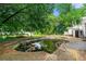 Backyard view of an in-ground swimming pool surrounded by lush greenery and mature trees at 486 Buttercup Trl, Lawrenceville, GA 30046