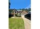 Charming brick two-story home with manicured landscaping, driveway, and a two-car garage at 7625 Cedar Grove Ct, Fairburn, GA 30213