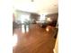 Large open kitchen with dark wood cabinets, an island with stools and hardwood flooring at 7625 Cedar Grove Ct, Fairburn, GA 30213