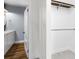 Modern bathroom with white vanity, wood floors, and a closet at 1730 Lee Peters Rd, Loganville, GA 30052