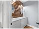 Bathroom featuring rustic wood accent wall, dual sinks, and white cabinetry at 1730 Lee Peters Rd, Loganville, GA 30052