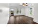 Bright bedroom featuring hardwood floors, white trim, and natural light from large windows at 1730 Lee Peters Rd, Loganville, GA 30052