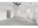 Spacious bedroom featuring carpet floors, overhead fan, and multiple doorways at 1730 Lee Peters Rd, Loganville, GA 30052
