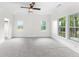 Bright and airy bedroom with neutral carpet, natural light, and an overhead fan at 1730 Lee Peters Rd, Loganville, GA 30052