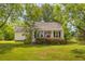 Charming home featuring a covered front porch and a well-manicured lawn at 1730 Lee Peters Rd, Loganville, GA 30052