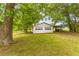 Detached two-car garage with white doors and mature trees at 1730 Lee Peters Rd, Loganville, GA 30052