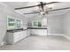 Bright kitchen with white cabinets, tile floors, and natural light creating a clean and inviting space at 1730 Lee Peters Rd, Loganville, GA 30052