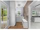 Mud room with white cabinets, wood wall paneling, and a sink at 1730 Lee Peters Rd, Loganville, GA 30052