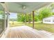 Covered rear porch with a ceiling fan, wood decking, and views of the backyard at 1730 Lee Peters Rd, Loganville, GA 30052
