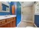 A full bathroom features ceramic tile floors, shower, and a wooden vanity at 1926 Parkwood Rd, Snellville, GA 30078
