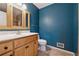Bathroom with a wooden vanity, ceramic tile floor, and a toilet at 1926 Parkwood Rd, Snellville, GA 30078
