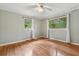 Light-filled bedroom with hardwood floors and windows offering views at 1926 Parkwood Rd, Snellville, GA 30078