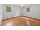 Bright bedroom features hardwood floors and two windows at 1926 Parkwood Rd, Snellville, GA 30078