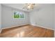 Light-filled bedroom with hardwood floors and large windows offering natural views at 1926 Parkwood Rd, Snellville, GA 30078